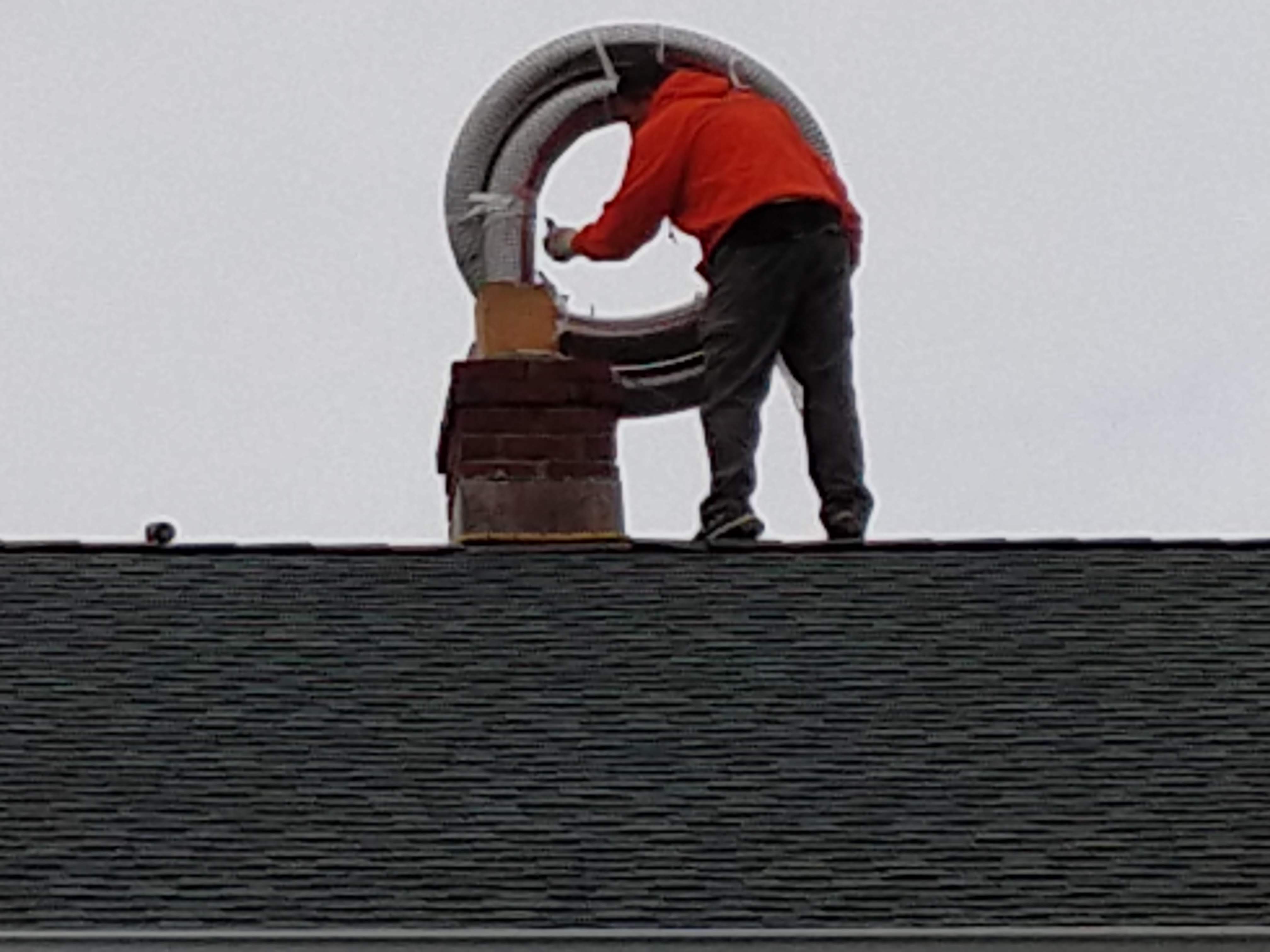 Flexible stainless chimney liner being installed in Valley Stream, New York